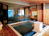 A guestroom with a private open-air hot spring bath attached